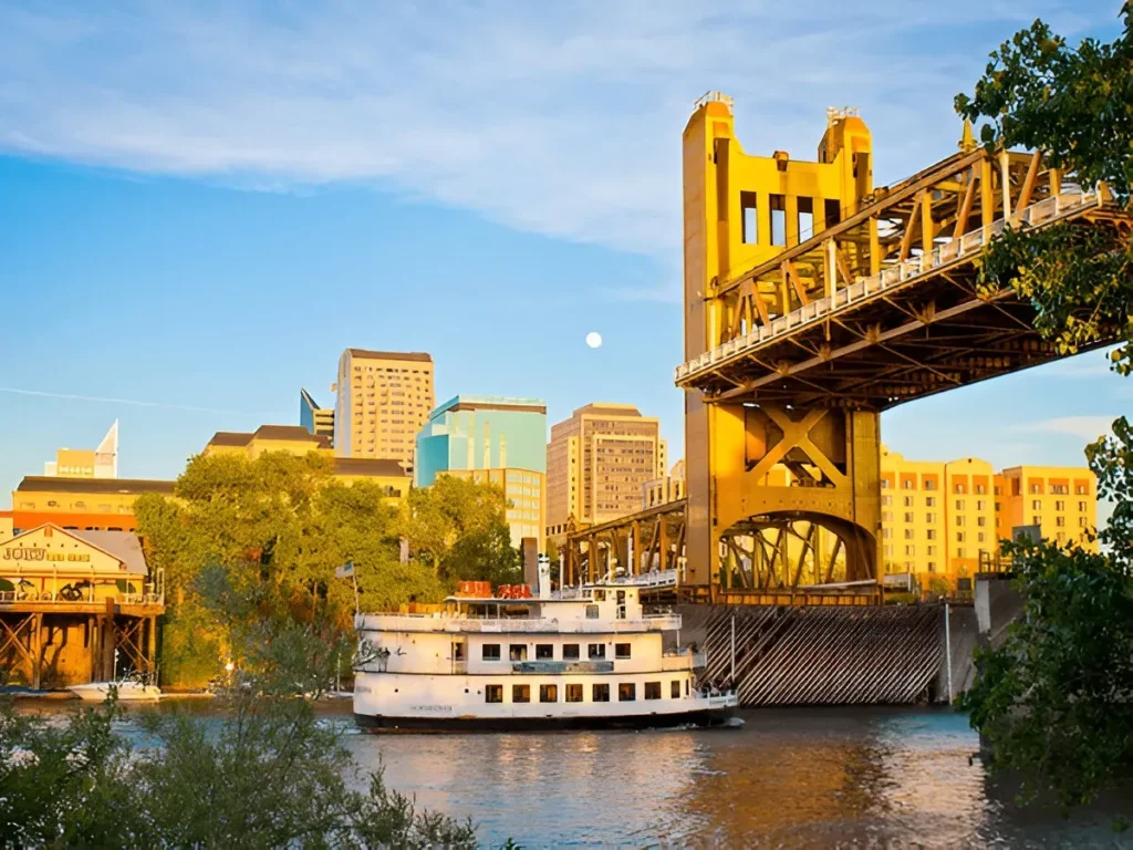 Downtown Sacramento skyline with Tower Bridge and a riverboat at sunset – digital marketing services Sacramento CA.