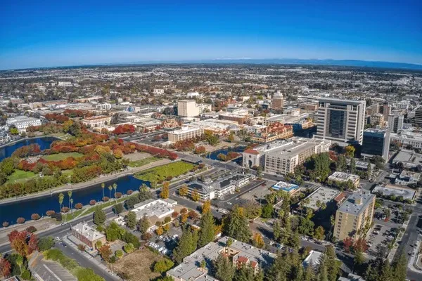 Aerial view of Stockton, California cityscape with buildings, parks, and waterways under a clear blue sky – digital marketing services Stockton CA.
