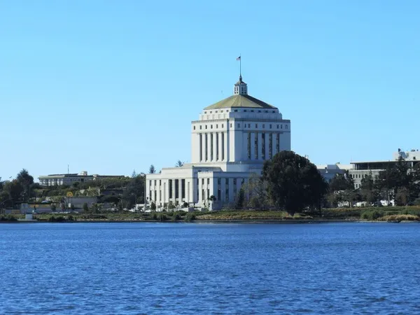 Alameda County Courthouse building in Oakland, CA viewed across Lake Merritt on a clear day.