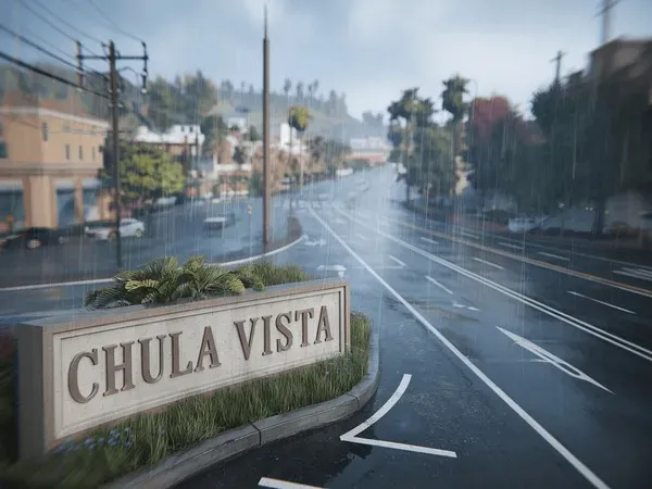 Rainy day street view with a Chula Vista city sign and palm trees in California