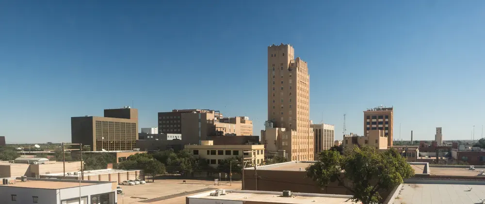Skyline view of downtown Abilene, Texas, featuring tall office buildings under a clear blue sky.