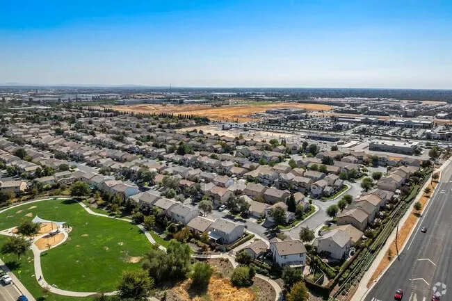 Aerial view of residential neighborhoods in Roseville, CA, with green parks, houses, and commercial areas under a clear blue sky. If you want an SEO-optimized version with your keyword, I can adjust it.