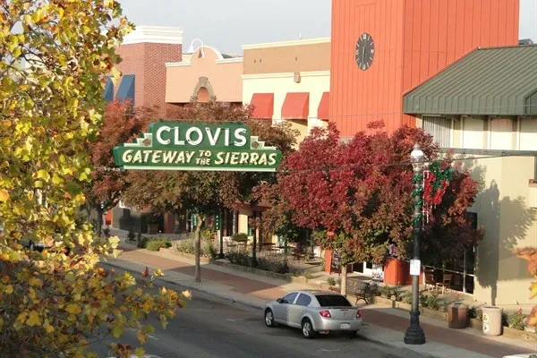 Downtown Clovis, CA with the “Gateway to the Sierras” sign, shops, and fall trees — ideal local imagery for digital marketing services in Clovis, CA.