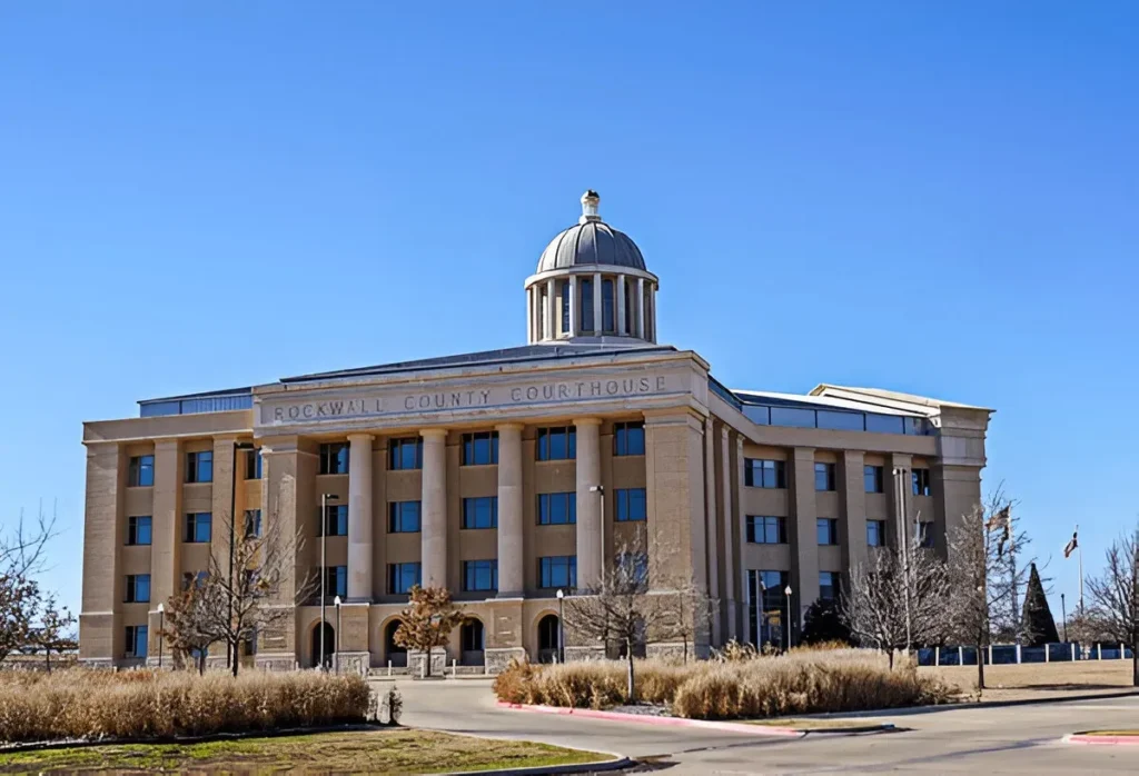 Rockwall County Courthouse in Texas with neoclassical architecture and a central dome under a clear blue sky